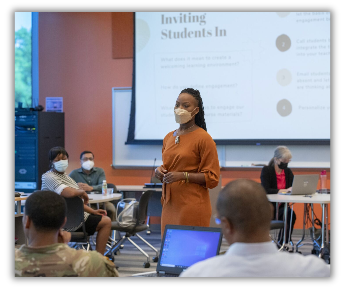Instructor leading faculty in a session title "Inviting Students In"