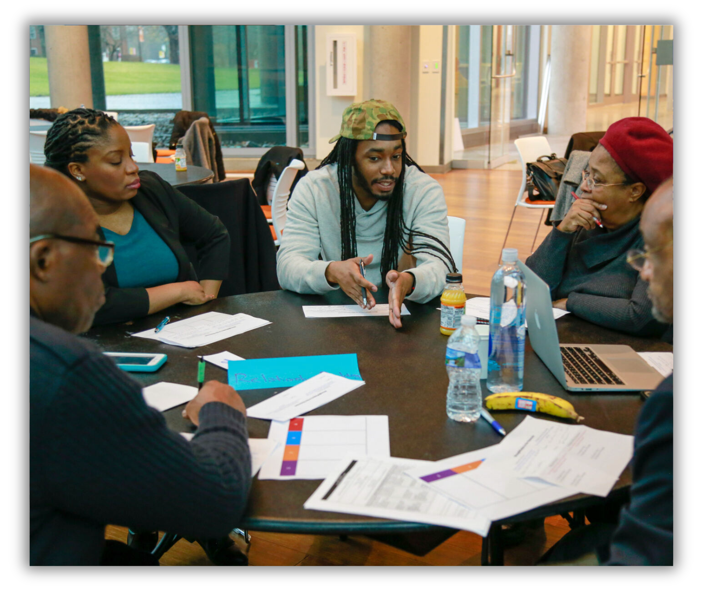 Group of faculty around a table in discussion