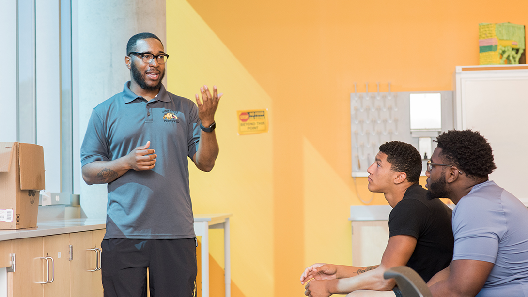 Coach Sewell talks with scholars